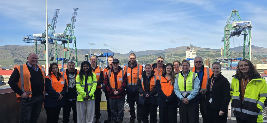 Members of Westland Milk Products' Environmental Management and Sustainability Teams stand in front of the Lyttelton Container Terminal.